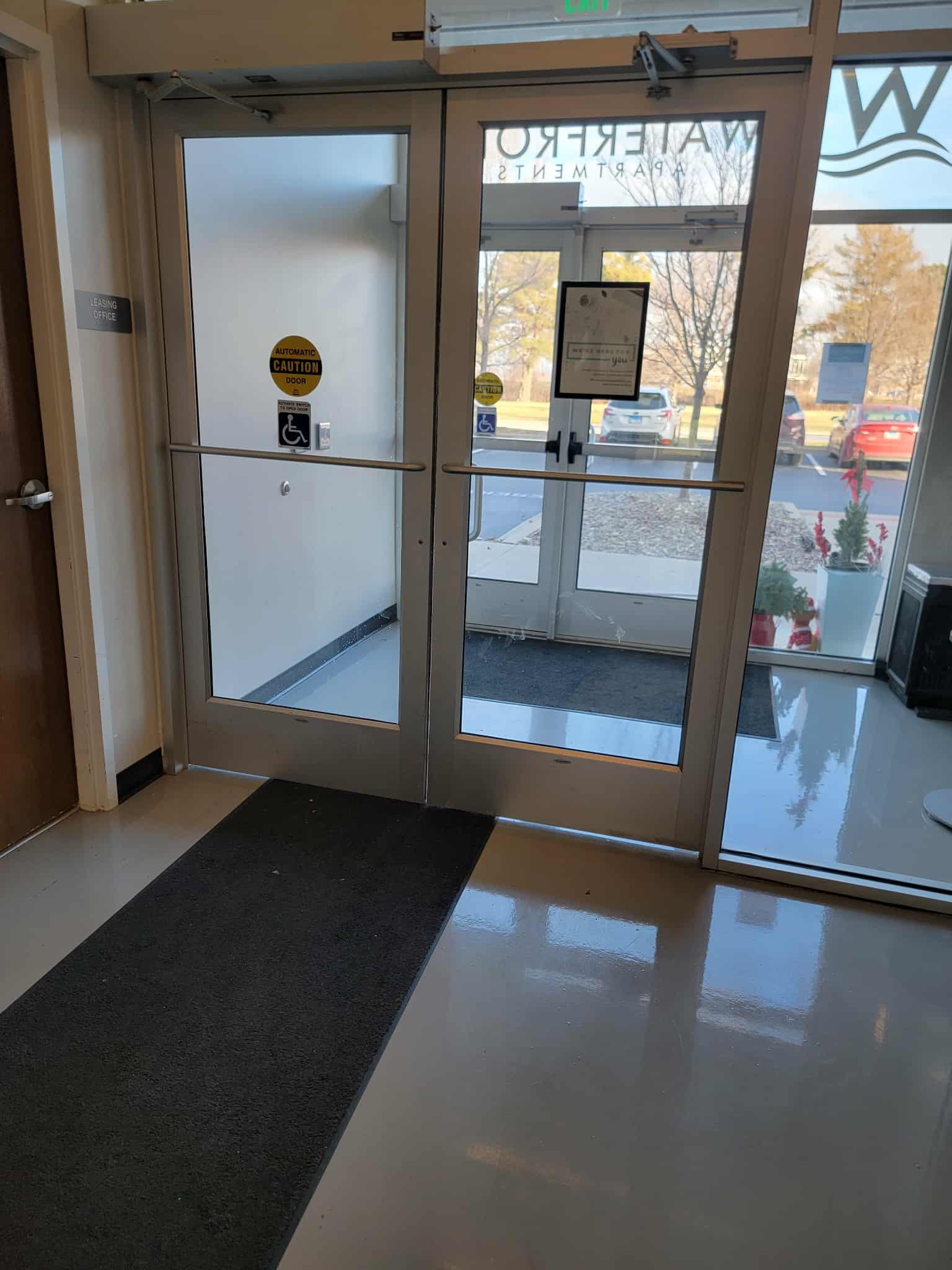 Glass door with a mat at the entrance of a building